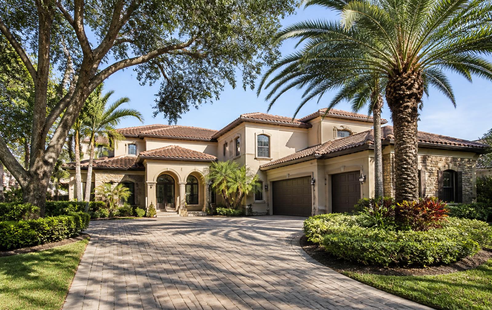 An established Wesley Chapel–area home with mature palms and landscaping in bright daylight