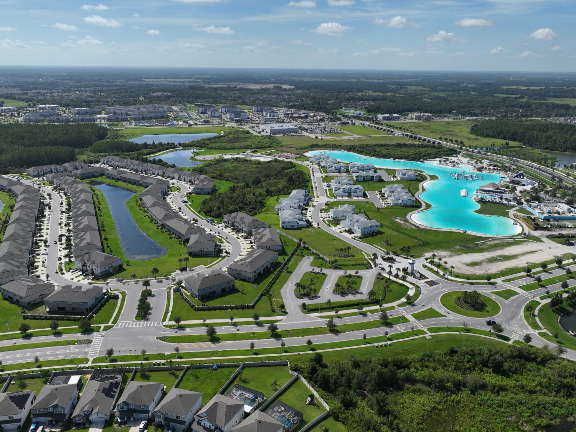 Aerial view of homes and a lagoon-style community amenity in Wesley Chapel, Florida